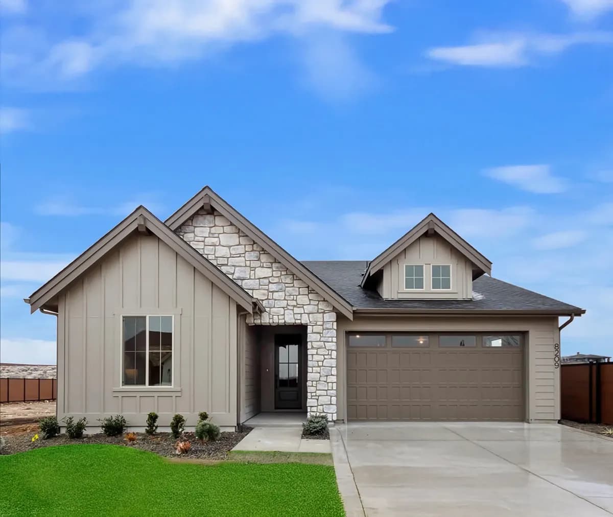 Grey exterior with stone facade on this new construction home Berkeley Building Co. Homes by Clayton.