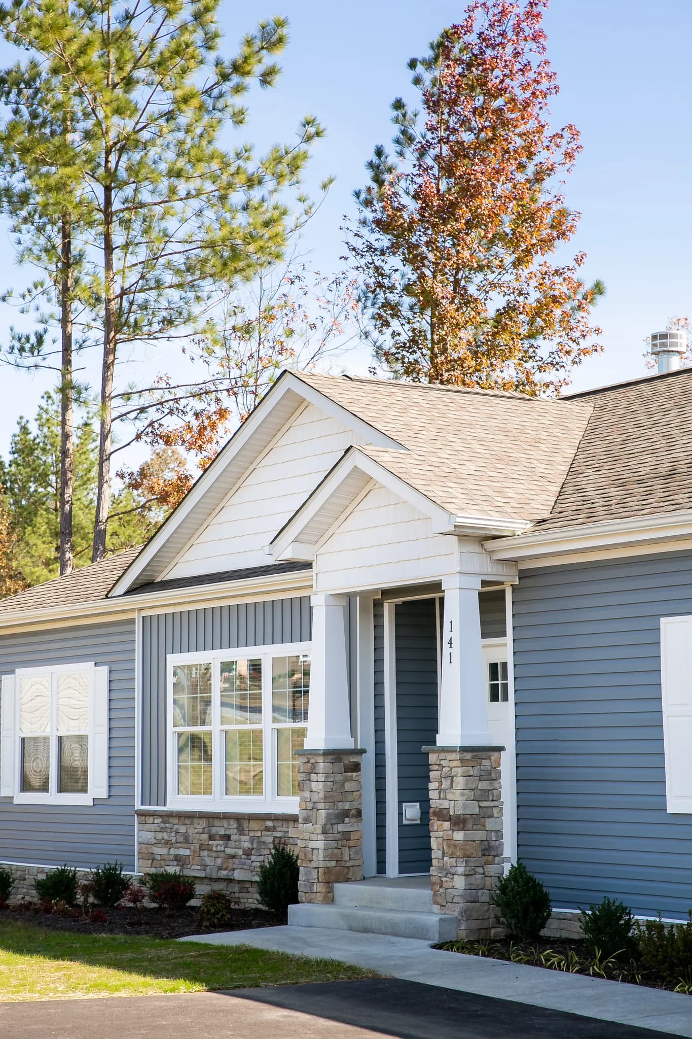 Blue and white exterior new construction Crossmod home built by Clayton.