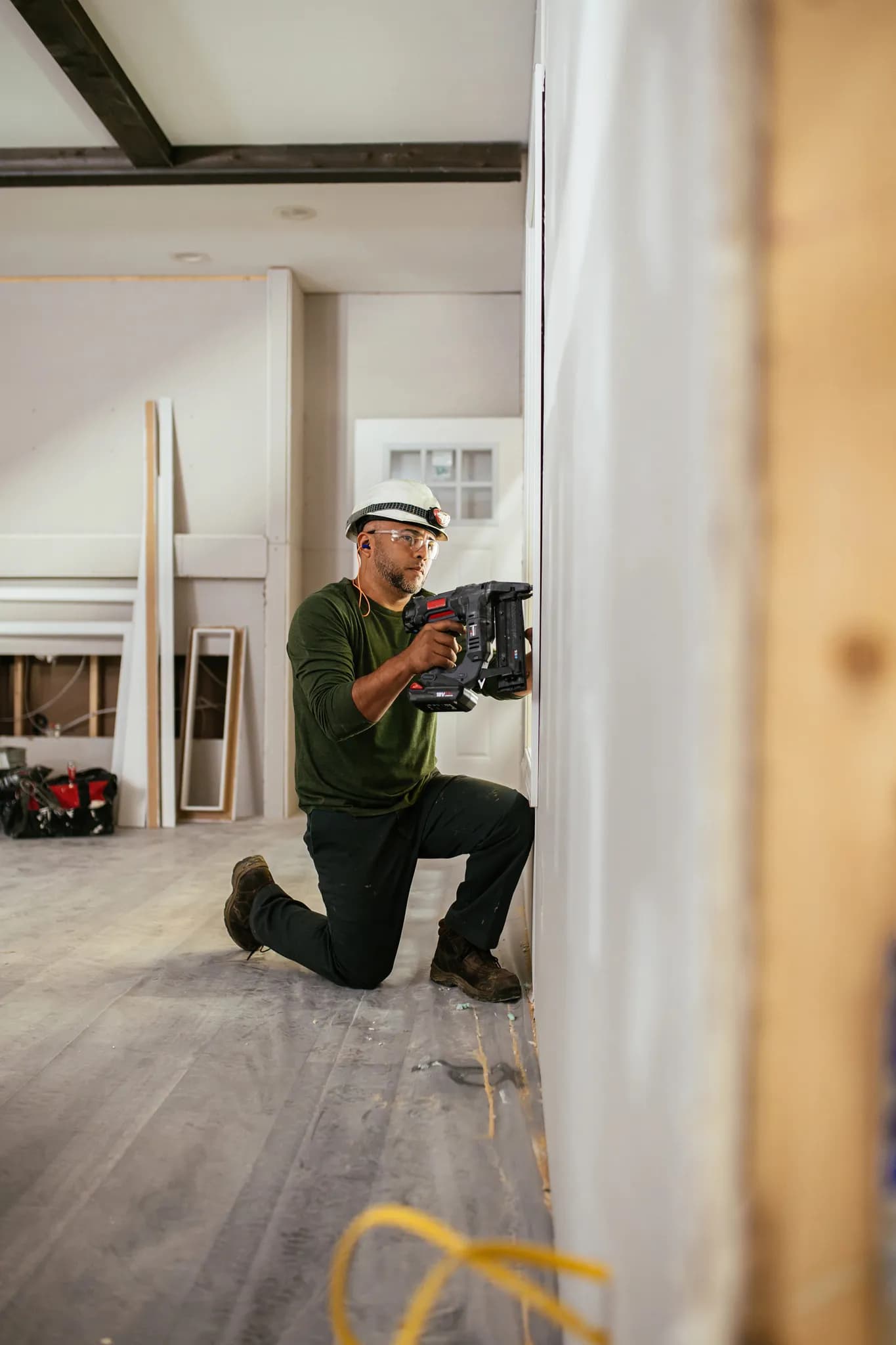A Clayton Homes team member places drywall in the interior of a new construction home during the building process.