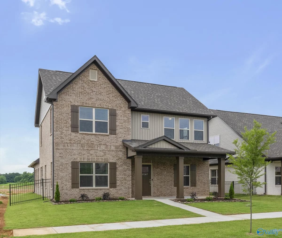 Two-story brick exterior new construction site-built home by Legacy Homes, a Clayton company.