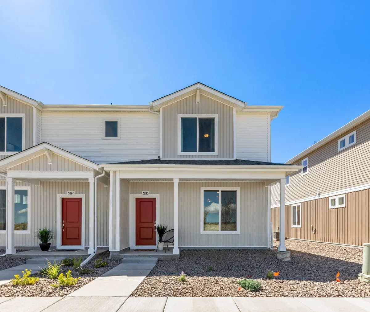 Cream and white exterior new construction two-story homes built by Oakwood Homes, a Clayton company.