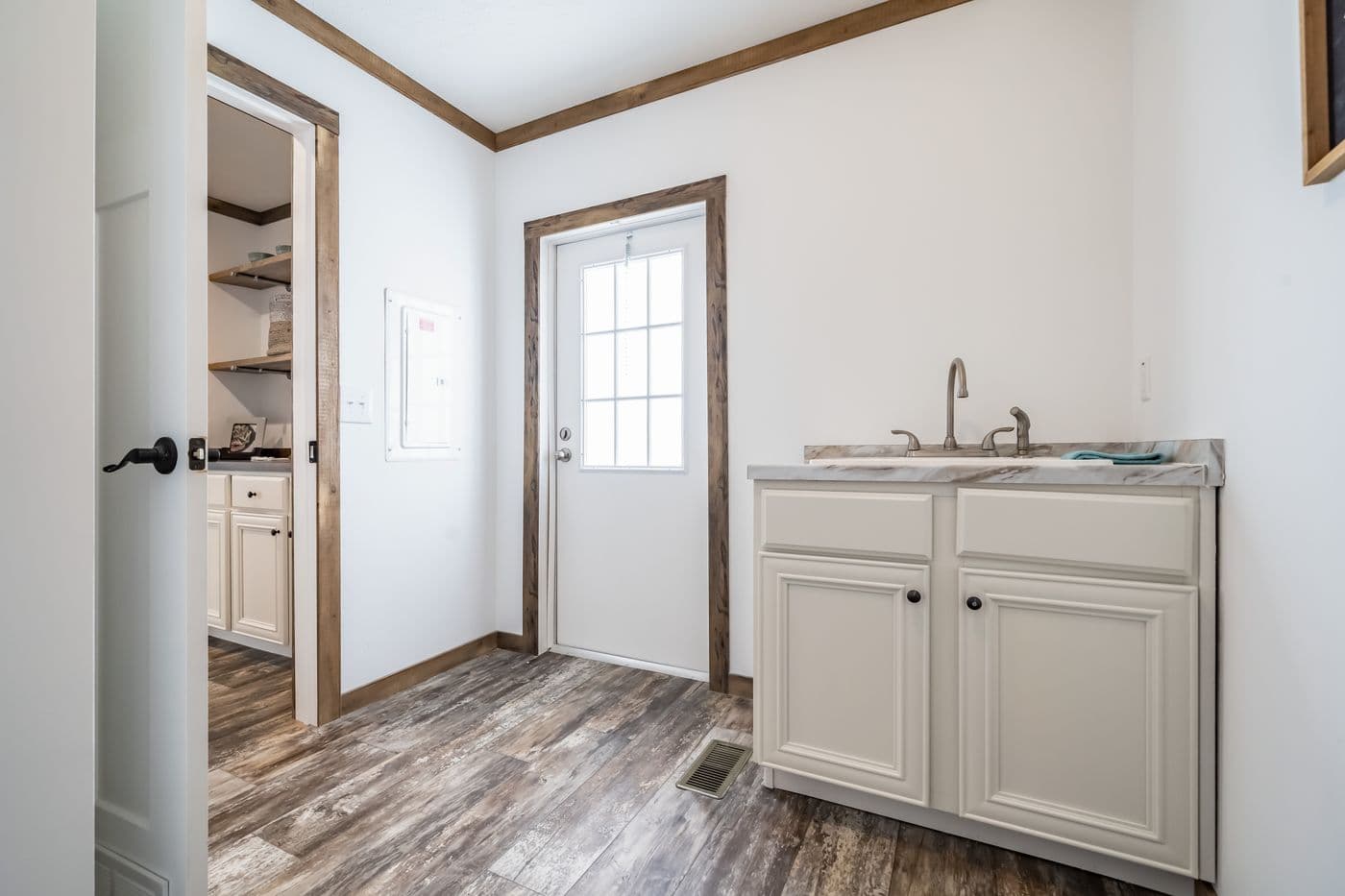 The THE EMMA JEAN Utility Room. This Manufactured Mobile Home features 4 bedrooms and 3 baths.