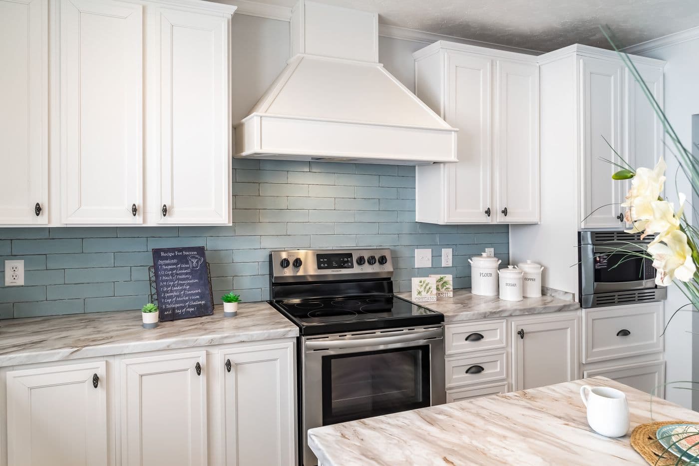 The THE INGRAM Kitchen. This Manufactured Mobile Home features 3 bedrooms and 2 baths.