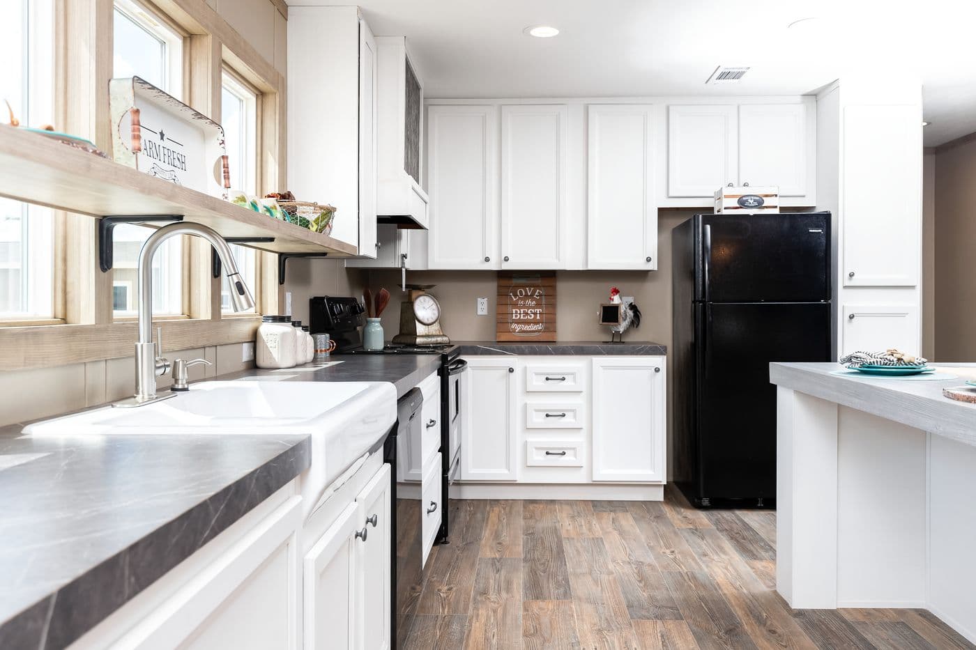 The FARMHOUSE FLEX Kitchen. This Manufactured Mobile Home features 3 bedrooms and 2.5 baths.