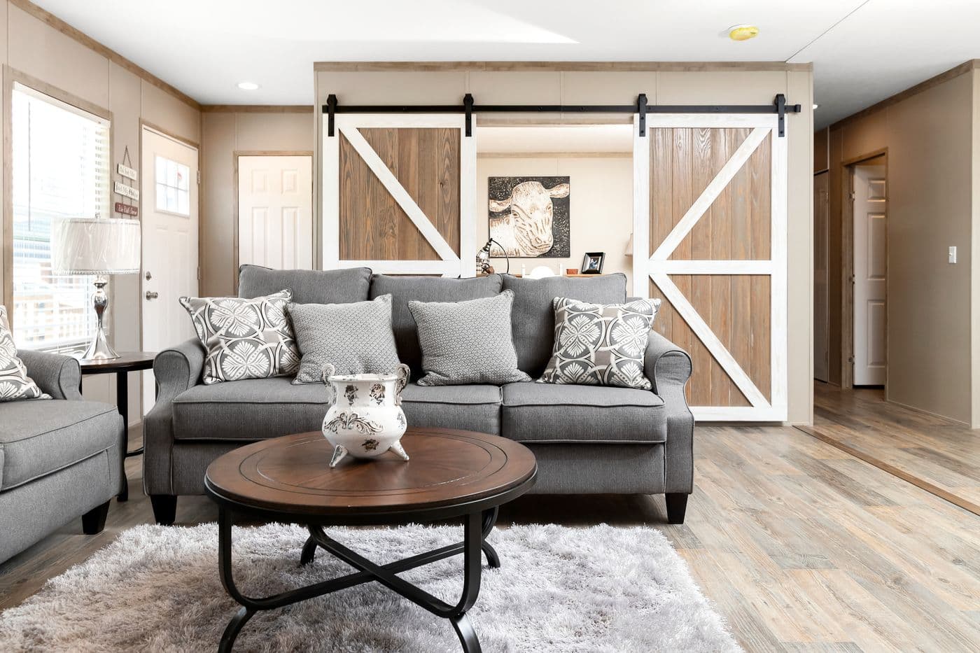 The FARMHOUSE FLEX Living Room. This Manufactured Mobile Home features 3 bedrooms and 2.5 baths.
