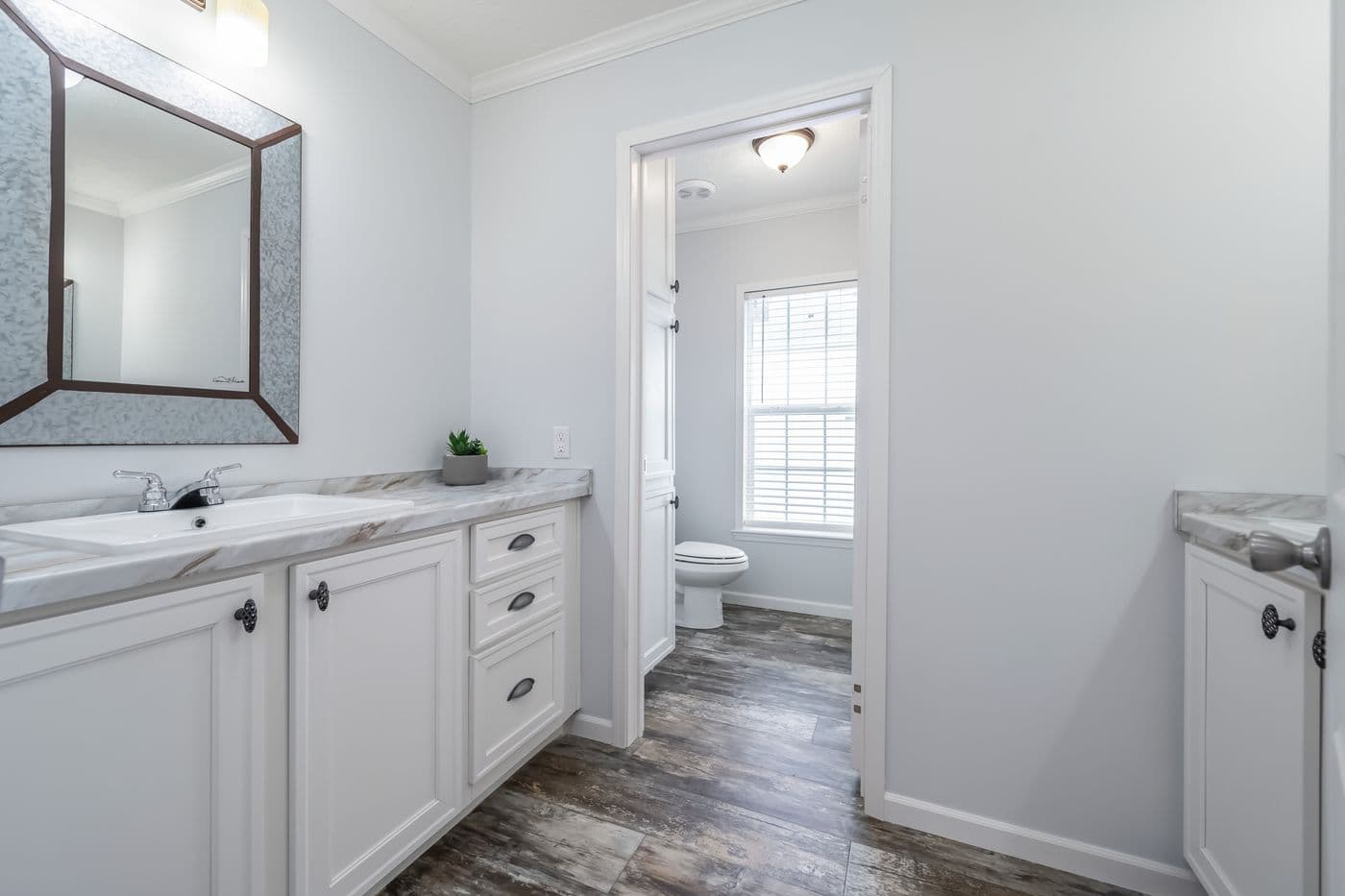 The THE LEAHY Guest Bathroom. This Manufactured Mobile Home features 4 bedrooms and 2 baths.