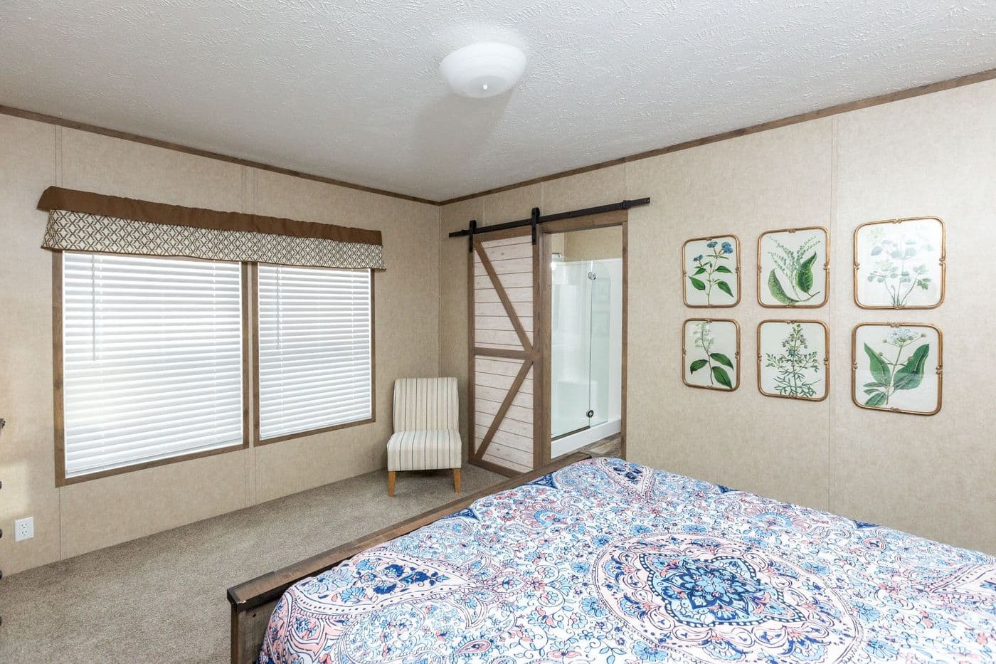 The THE RANCH HOUSE Primary Bedroom. This Manufactured Mobile Home features 3 bedrooms and 2 baths.