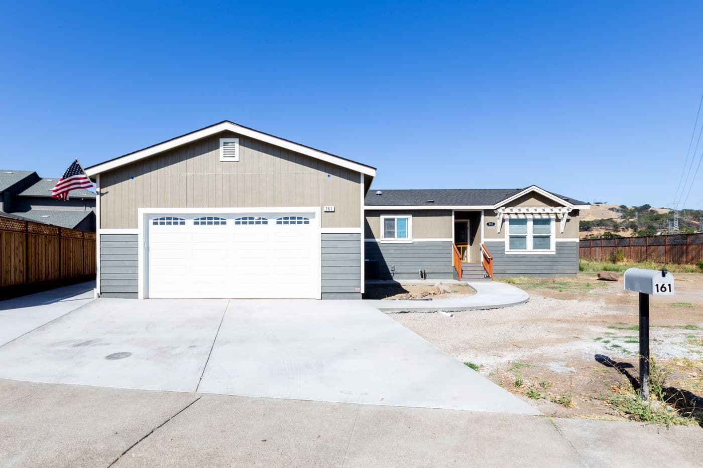 The CORONADO 24563C Trellis Exterior with Garage. This Manufactured Mobile Home features 3 bedrooms and 2 baths.