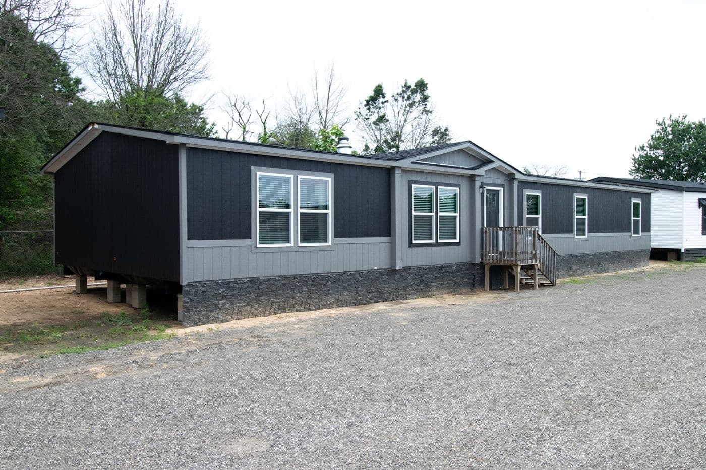 The ABSOLUTE VALUE Exterior. This Manufactured Mobile Home features 4 bedrooms and 2 baths.