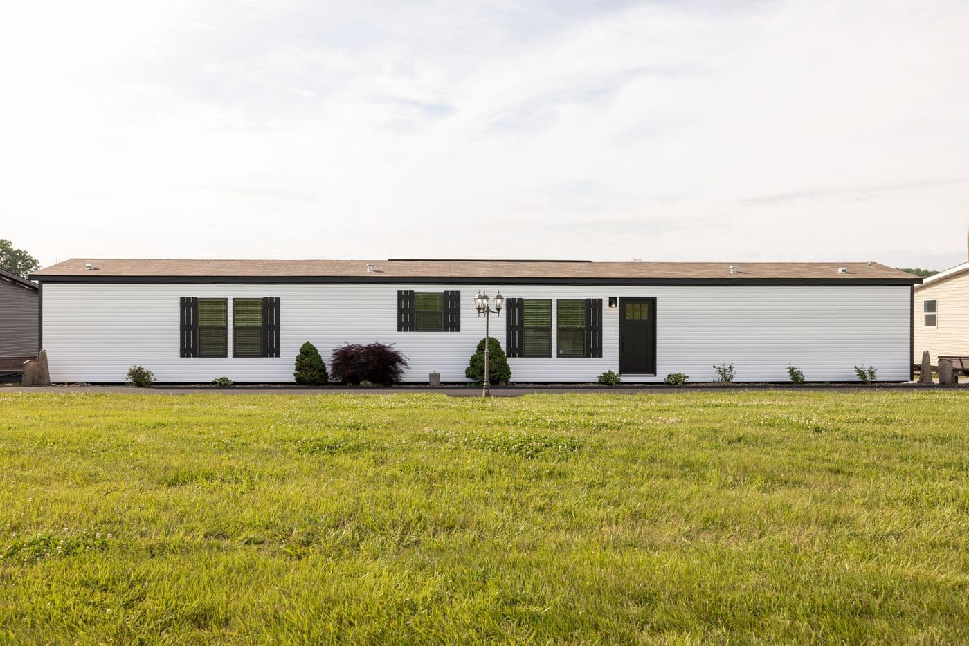 The SHOWER HOUSE Exterior. This Manufactured Mobile Home features 3 bedrooms and 2 baths.