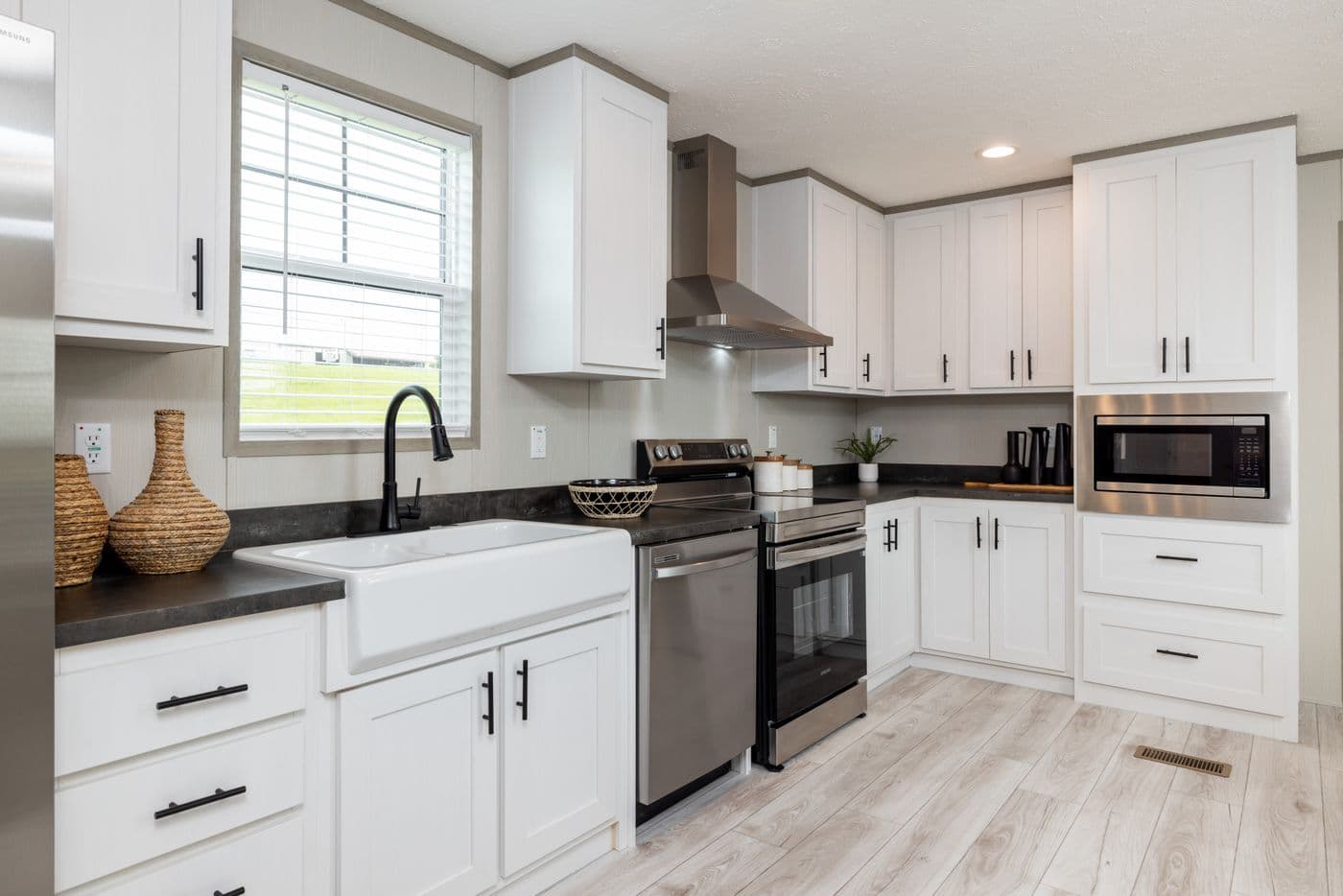 The SHOWER HOUSE Kitchen. This Manufactured Mobile Home features 3 bedrooms and 2 baths.