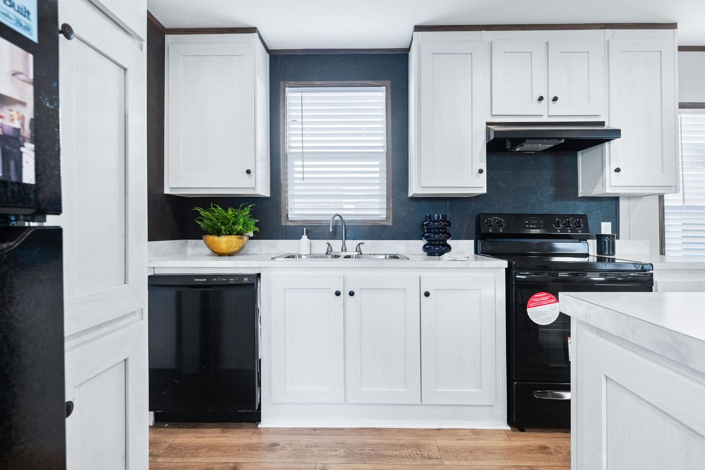 The HOMESTEAD 16763A Kitchen. This Manufactured Mobile Home features 3 bedrooms and 2 baths.