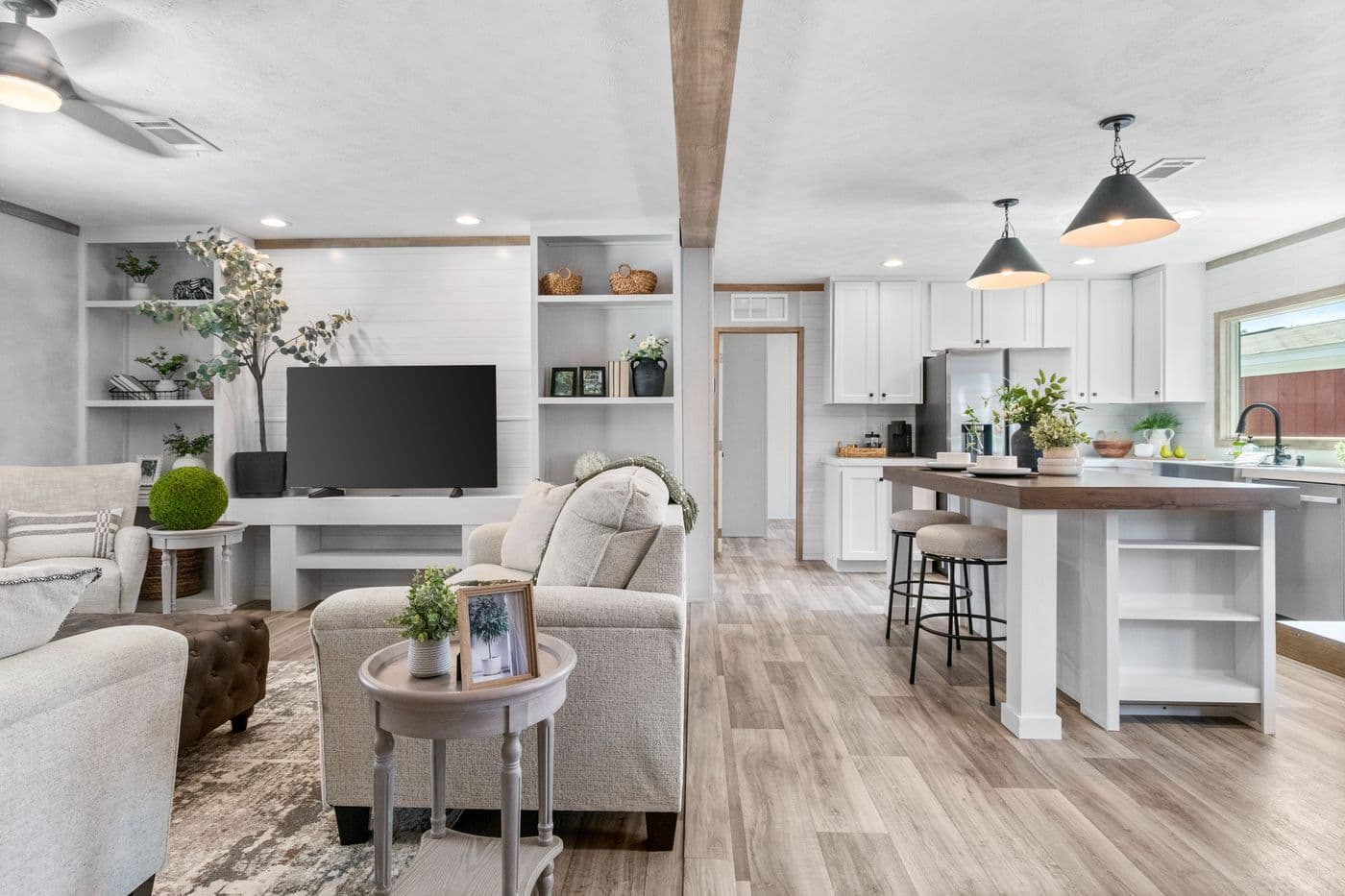 The THE REAL DEAL Living Room. This Manufactured Mobile Home features 3 bedrooms and 2 baths.