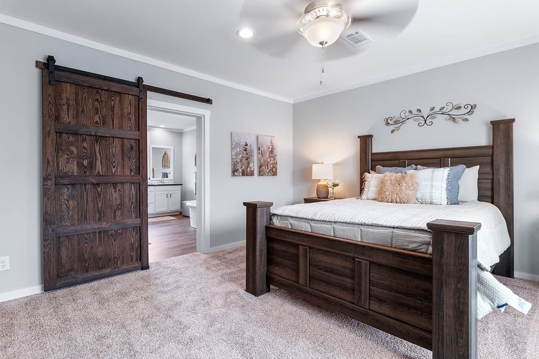 The THE OCEANSIDE Primary Bedroom. This Manufactured Mobile Home features 4 bedrooms and 3 baths.