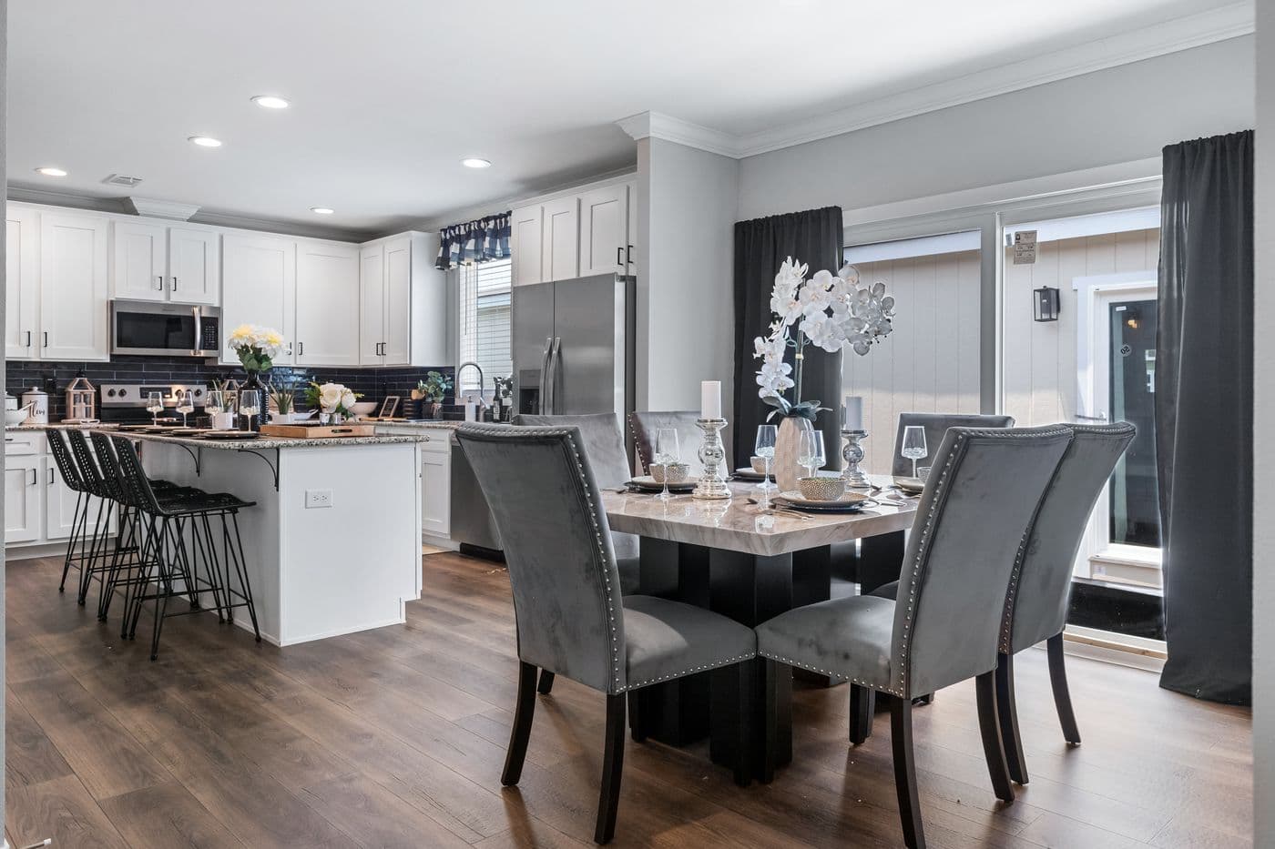 The THE MONTERREY Dining Area. This Manufactured Mobile Home features 4 bedrooms and 3 baths.
