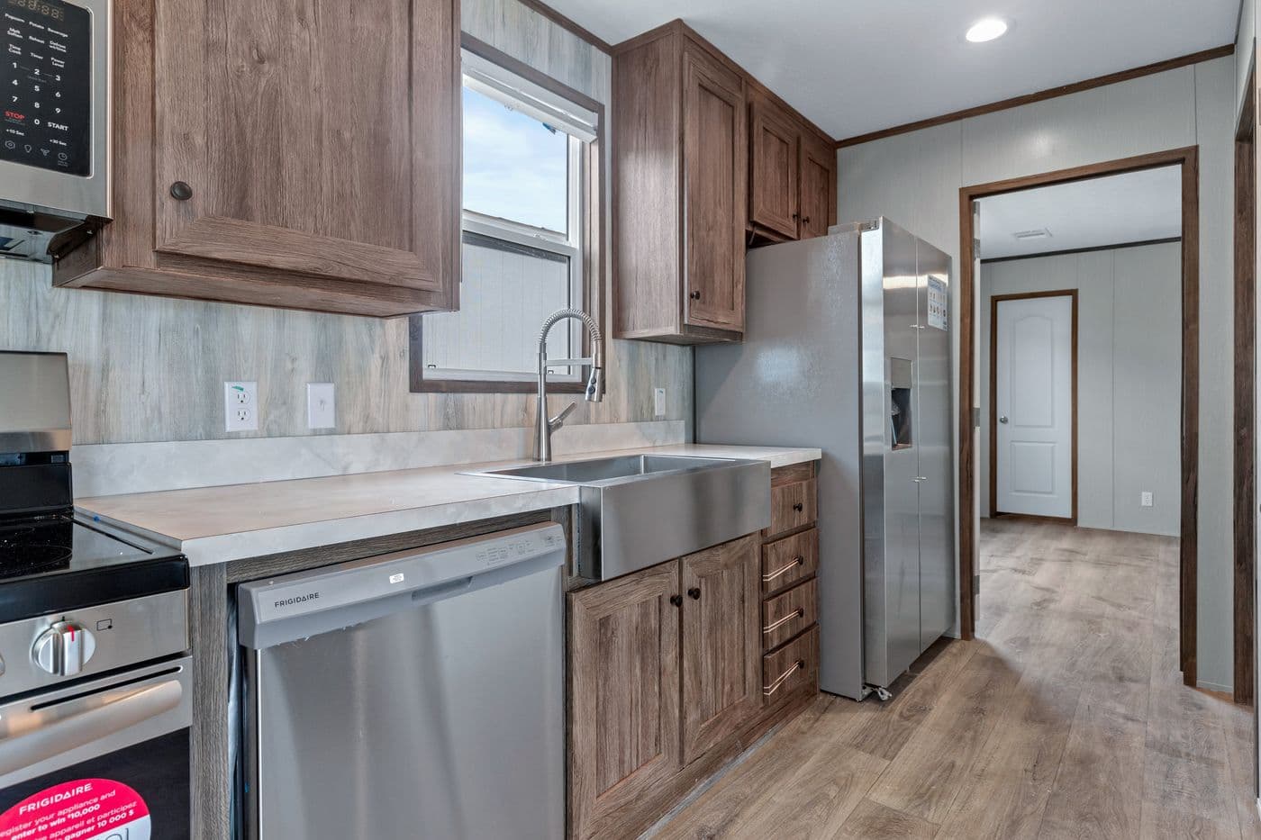 The ANNIVERSARY 16683B Kitchen. This Manufactured Mobile Home features 3 bedrooms and 2 baths.