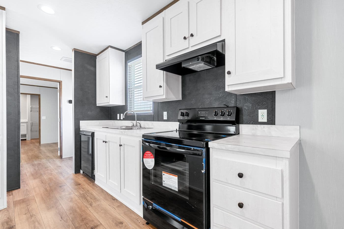 The HOMESTEAD 16602A Kitchen. This Manufactured Mobile Home features 2 bedrooms and 2 baths.