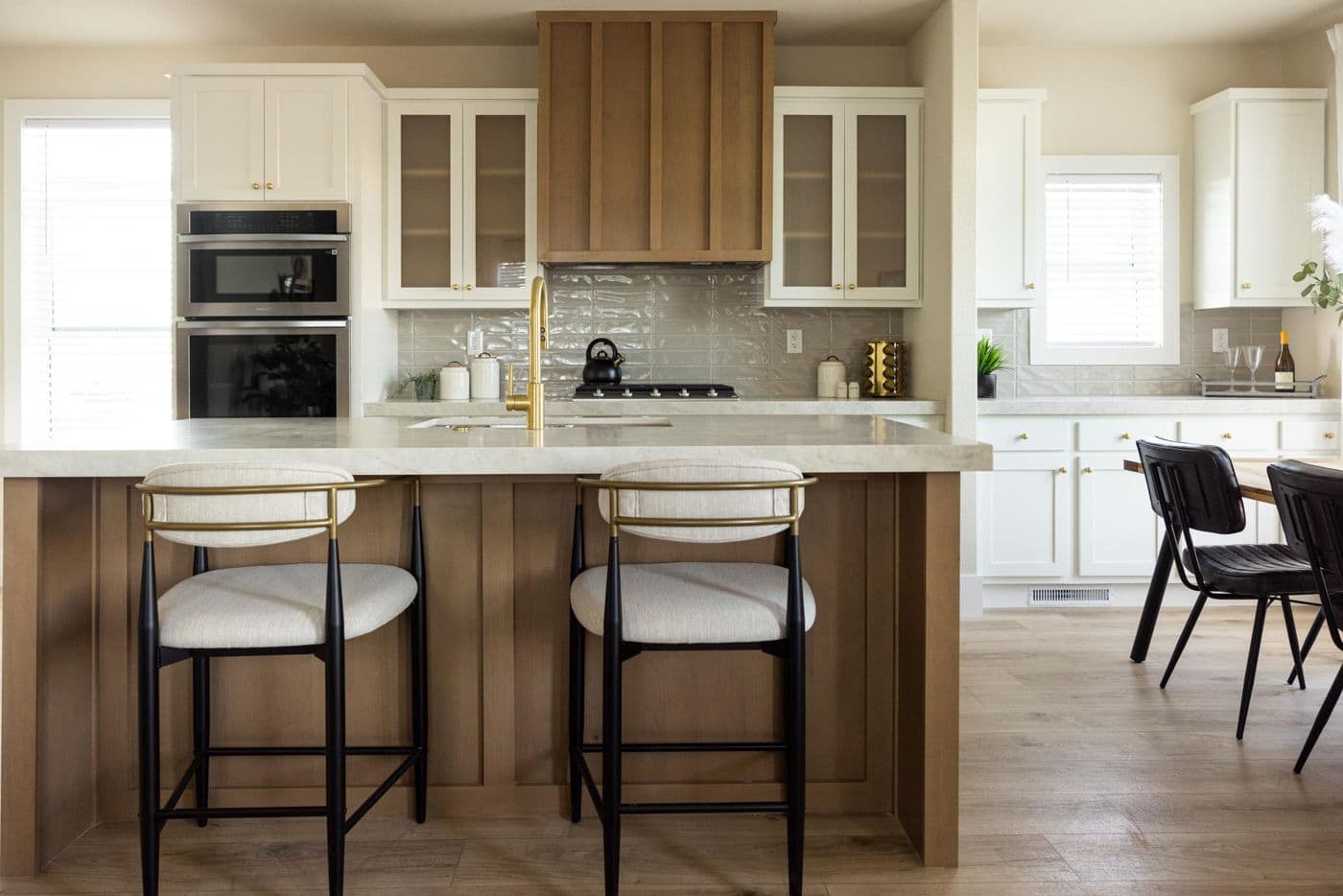 The ELEANOR Exterior. This modern manufactured home features an elevated kitchen with an island, built-in oven, and gas range. 