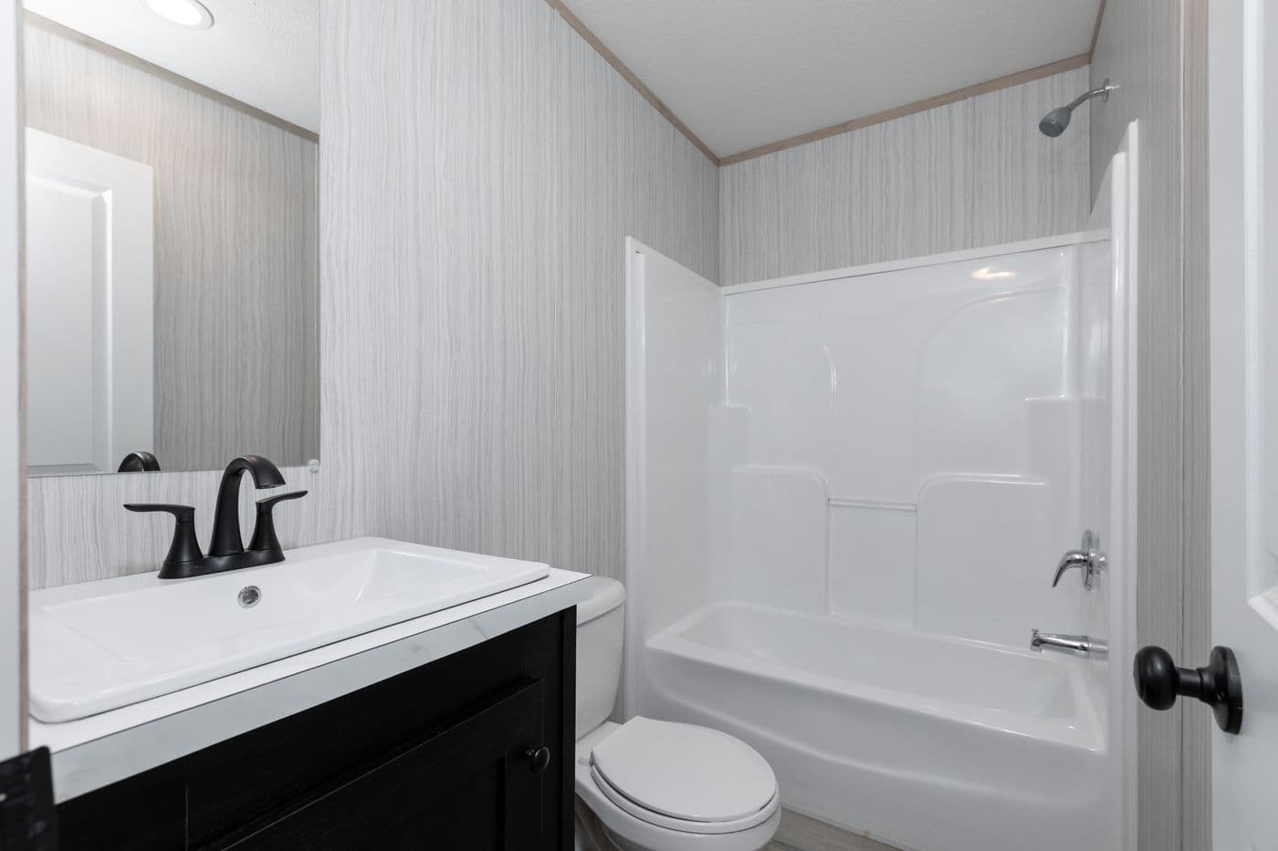 The THE ANNIVERSARY ISLANDER Guest Bathroom. This Manufactured Mobile Home features 3 bedrooms and 2 baths.