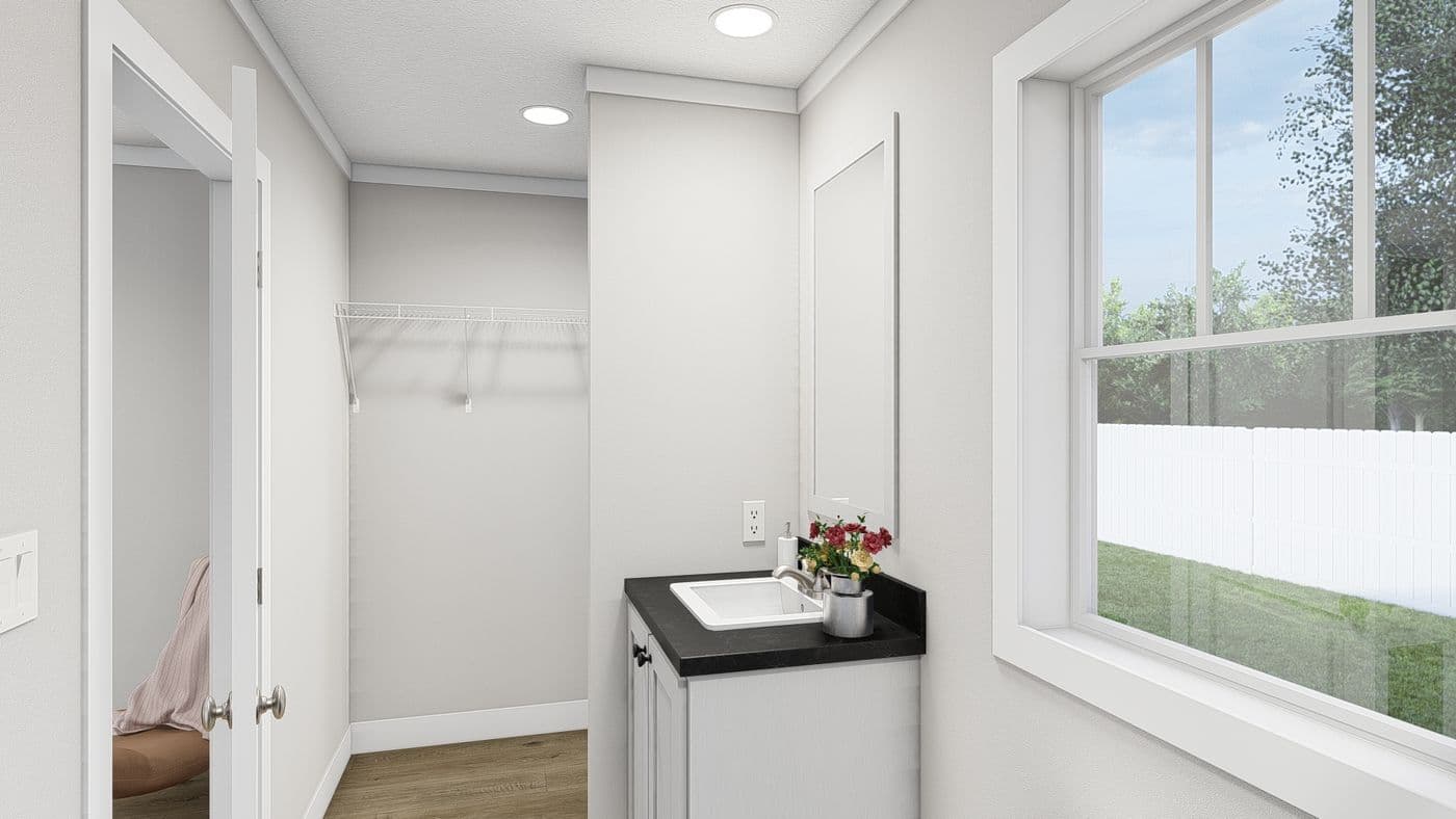 The MOVE ON UP Primary Bathroom. This Manufactured Mobile Home features 3 bedrooms and 2 baths.