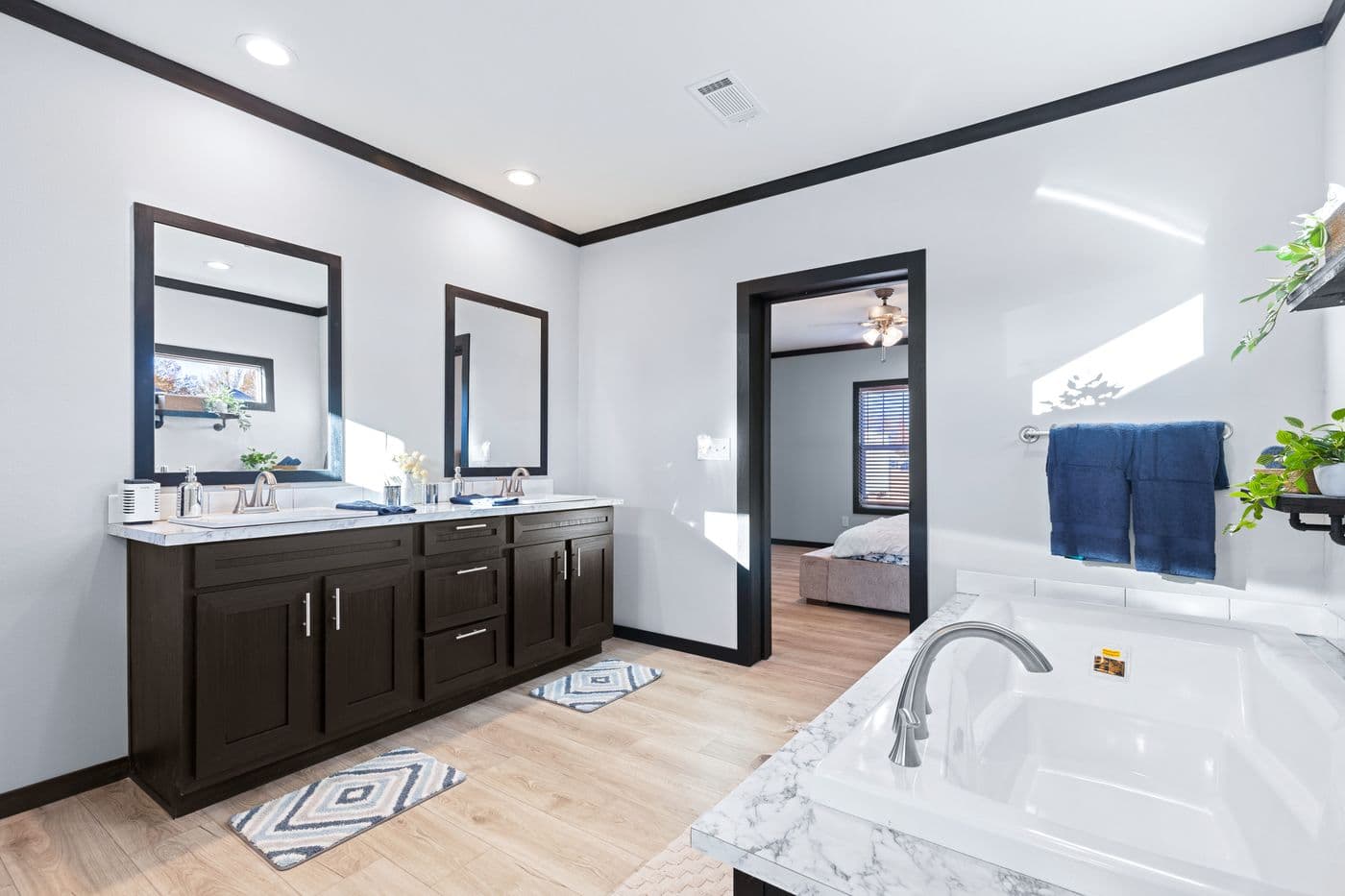 The THE LOUIS Primary Bathroom. This Manufactured Mobile Home features 4 bedrooms and 3 baths.