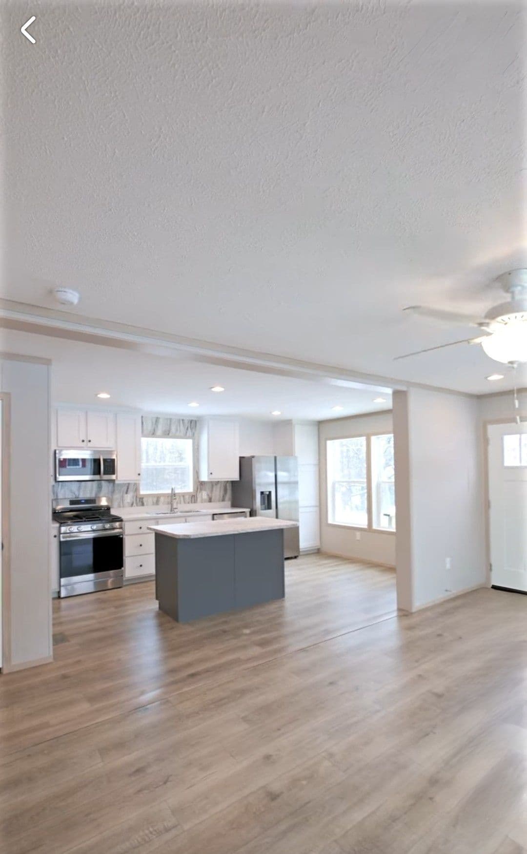 The TURQUOISE Living Room. This Manufactured Mobile Home features 2 bedrooms and 2 baths.