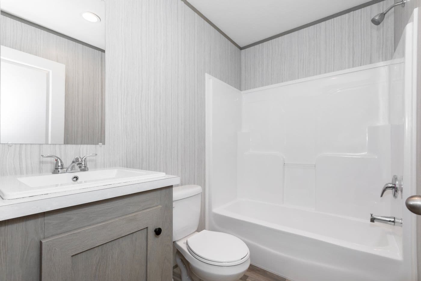 The THE OLYMPUS Guest Bathroom. This Manufactured Mobile Home features 3 bedrooms and 2 baths.