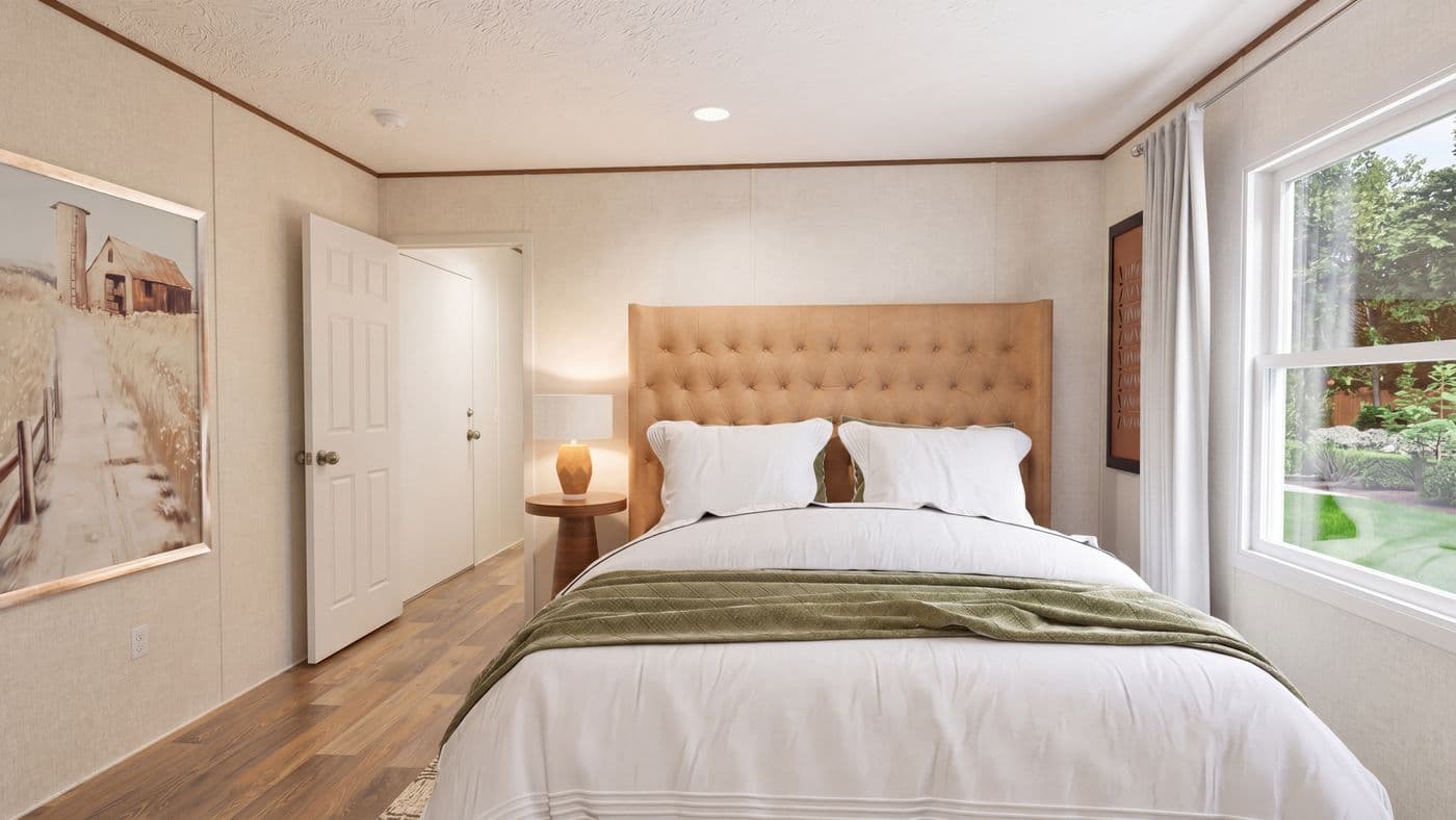 The DOGWOOD Primary Bedroom. This Manufactured Mobile Home features 2 bedrooms and 2 baths.