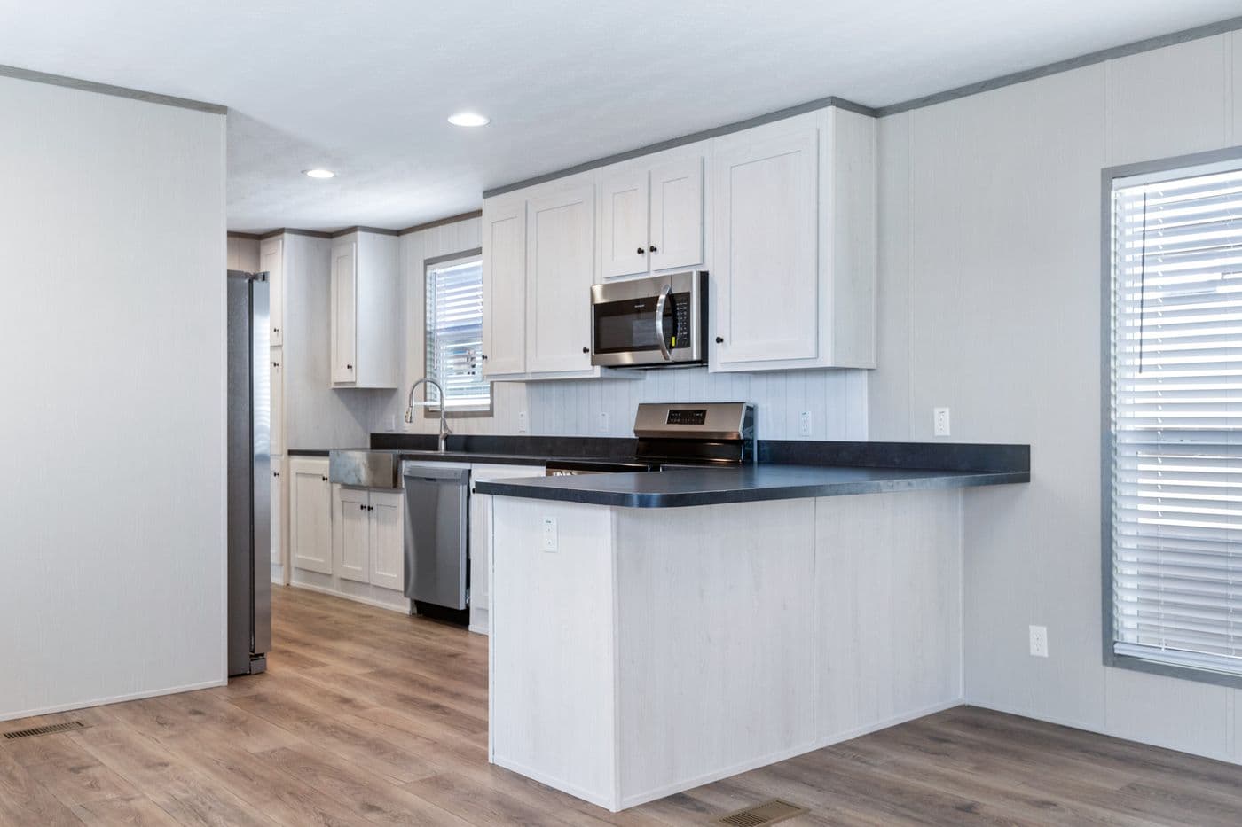The RESOLUTION 16763K Kitchen. This Manufactured Mobile Home features 3 bedrooms and 2 baths.