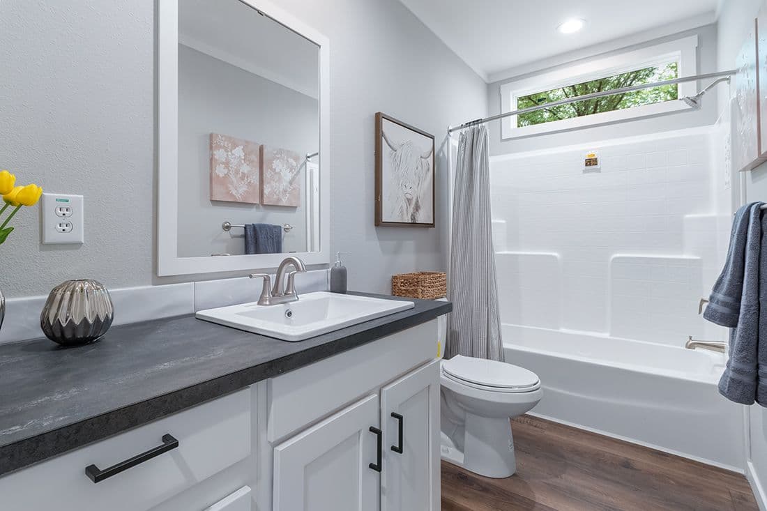The THE OCEANSIDE Guest Bathroom. This Manufactured Mobile Home features 4 bedrooms and 3 baths.