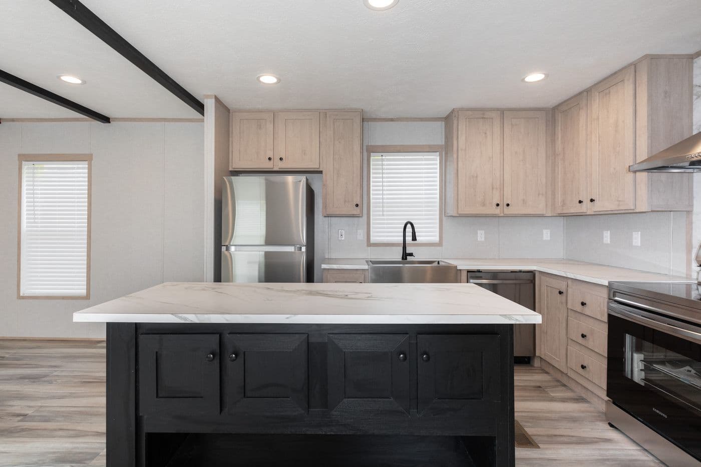 The THE ANNIVERSARY ISLANDER Kitchen. This Manufactured Mobile Home features 3 bedrooms and 2 baths.