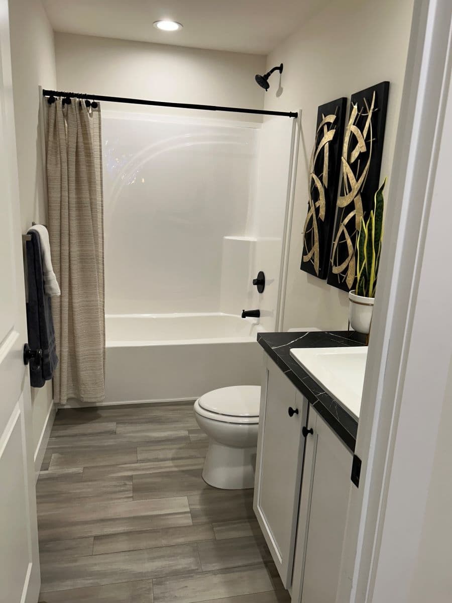 The STRATFORD PL 6630-MS062 SECT Guest Bathroom. This Manufactured Mobile Home features 3 bedrooms and 2 baths.