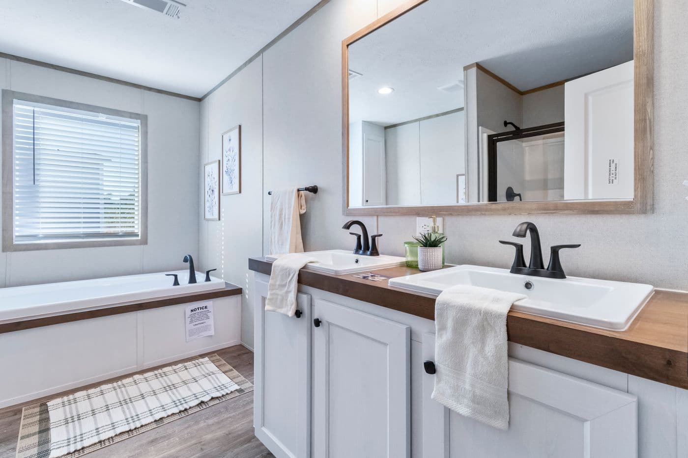 The THE BIG DEAL 52 Primary Bathroom. This Manufactured Mobile Home features 3 bedrooms and 2 baths.