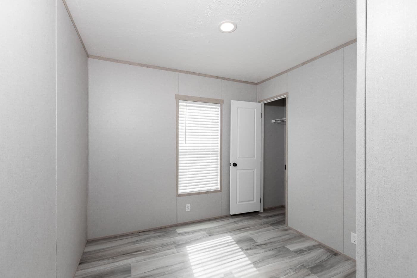 The THE ANNIVERSARY ISLANDER Guest Bedroom. This Manufactured Mobile Home features 3 bedrooms and 2 baths.