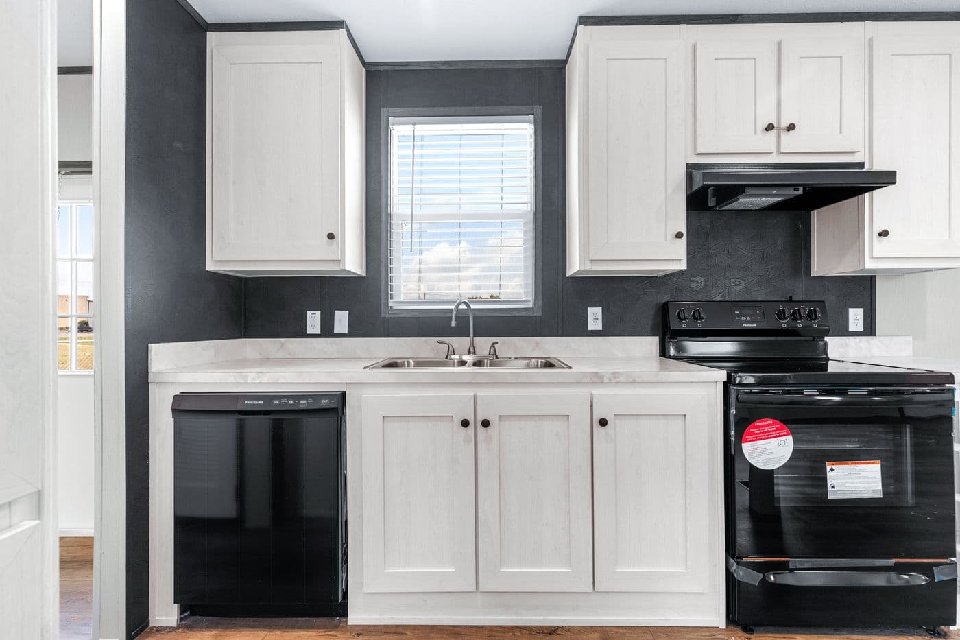 The HOMESTEAD 16602A Kitchen. This Manufactured Mobile Home features 2 bedrooms and 2 baths.