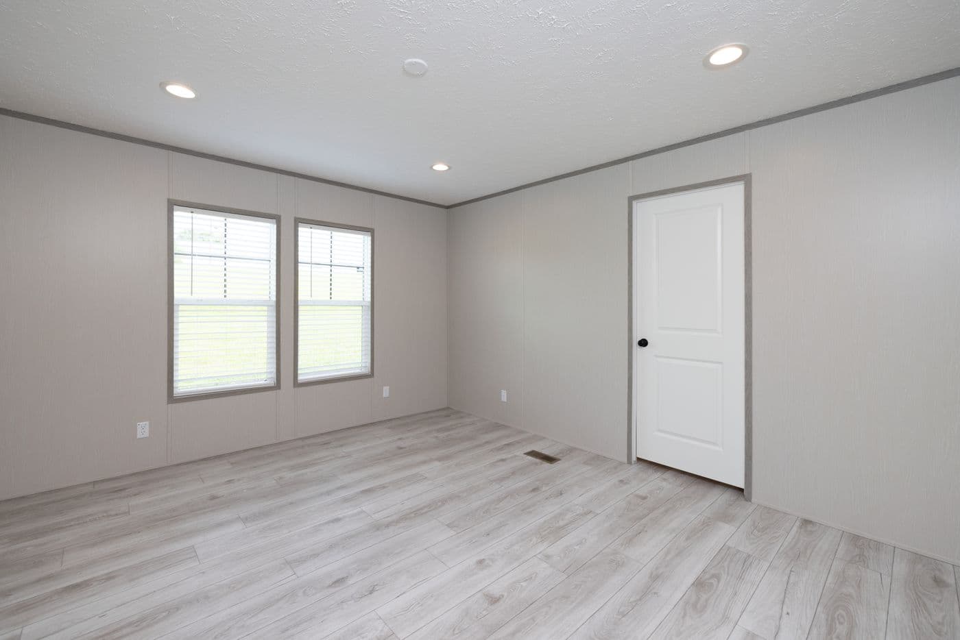 The SHOWER HOUSE Primary Bedroom. This Manufactured Mobile Home features 3 bedrooms and 2 baths.