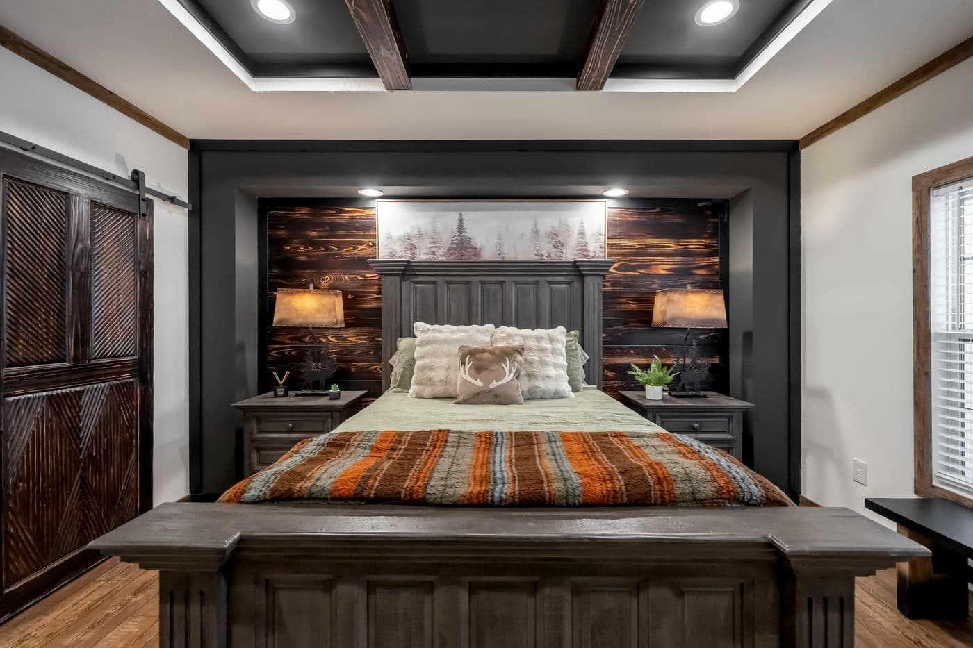 The THE MILL HOUSE Primary Bedroom. This Manufactured Mobile Home features 3 bedrooms and 2 baths.
