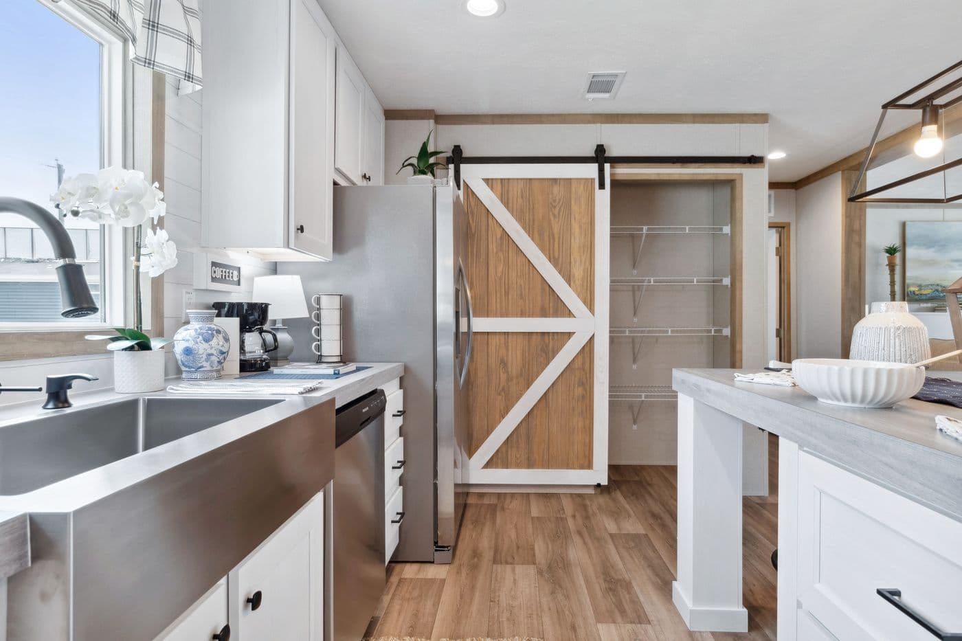 The BREEZE FARMHOUSE 72 Kitchen. This Manufactured Mobile Home features 4 bedrooms and 2 baths.