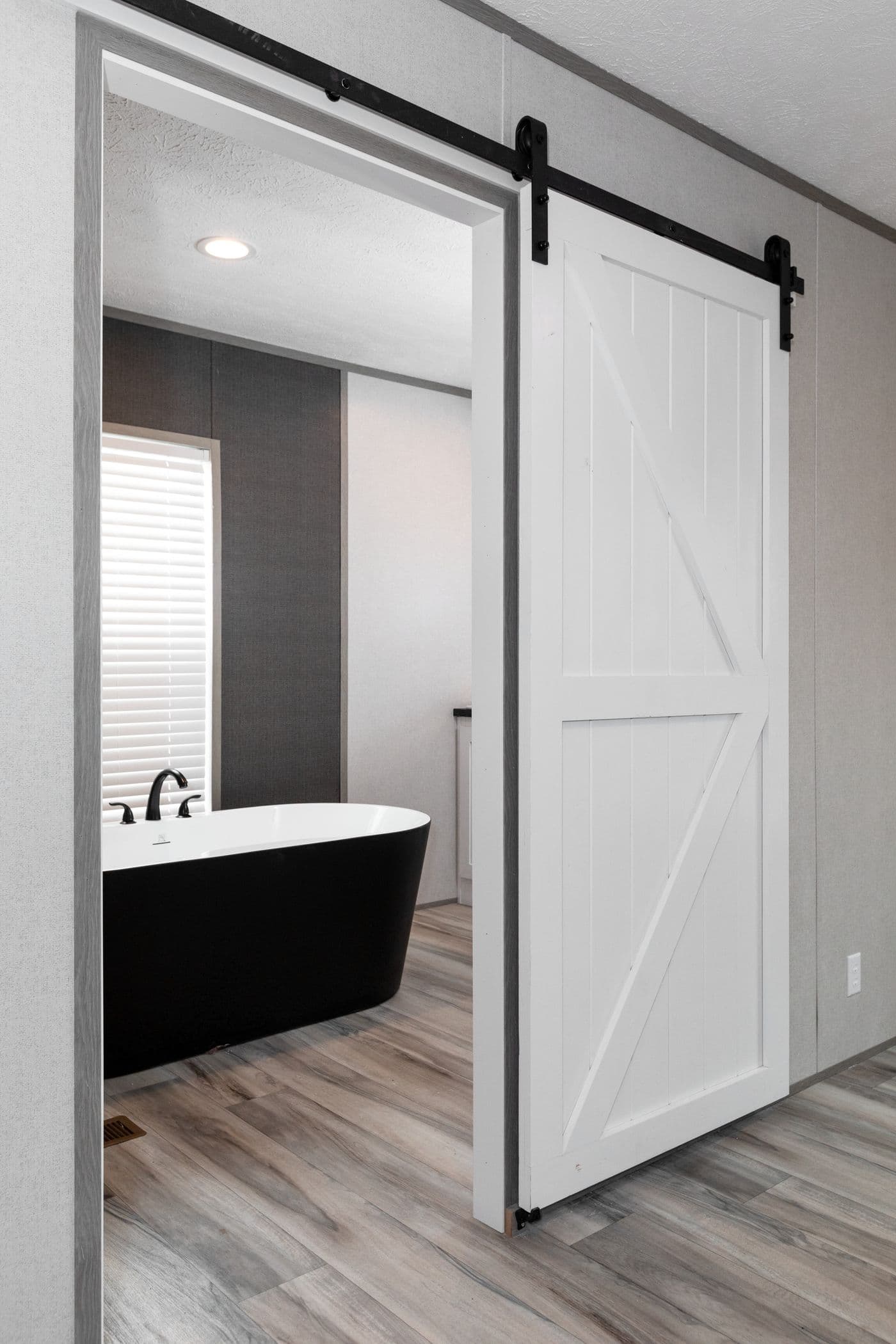 The PLATINUM ANNIVERSARY Primary Bedroom. This Manufactured Mobile Home features 3 bedrooms and 2 baths.
