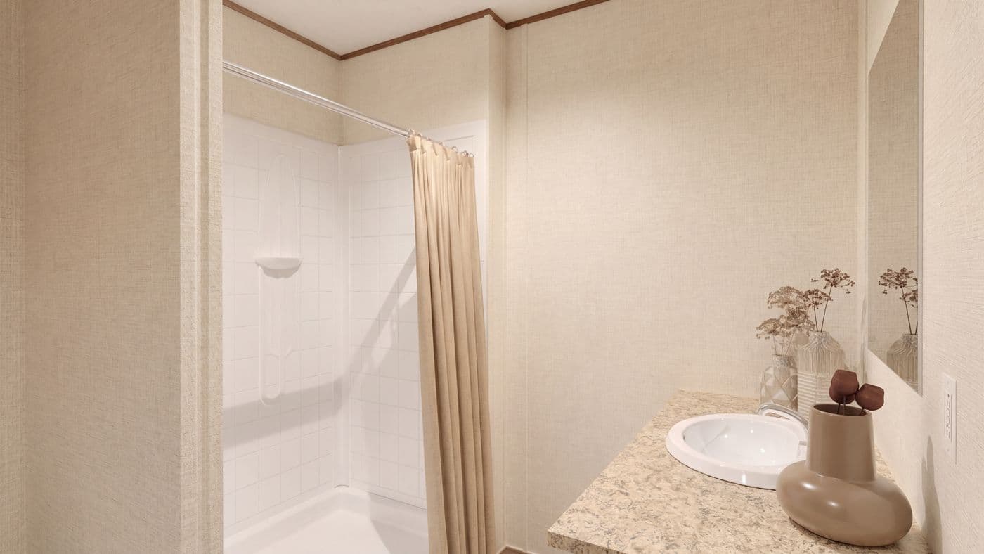 The REDWOOD Primary Bathroom. This Manufactured Mobile Home features 5 bedrooms and 3 baths.