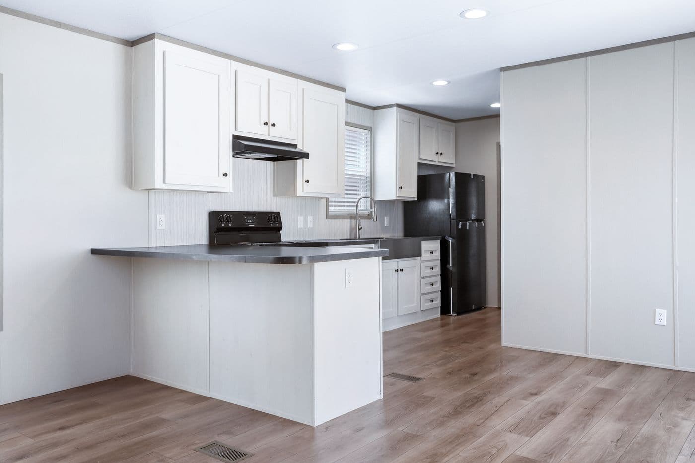 The ANNIVERSARY 16602A Kitchen. This Manufactured Mobile Home features 2 bedrooms and 2 baths.