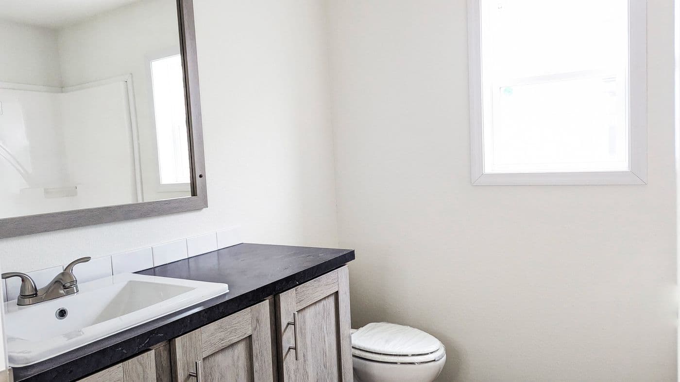 The RAMSEY 210-1 Primary Bathroom. This Manufactured Mobile Home features 2 bedrooms and 1 bath.