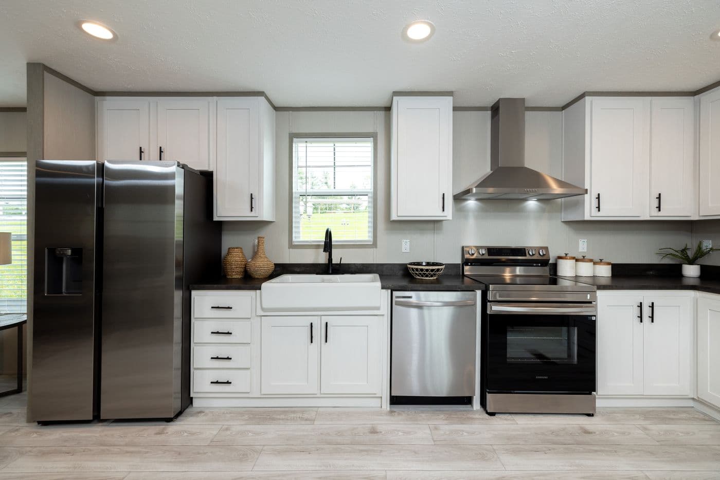 The SHOWER HOUSE Kitchen. This Manufactured Mobile Home features 3 bedrooms and 2 baths.
