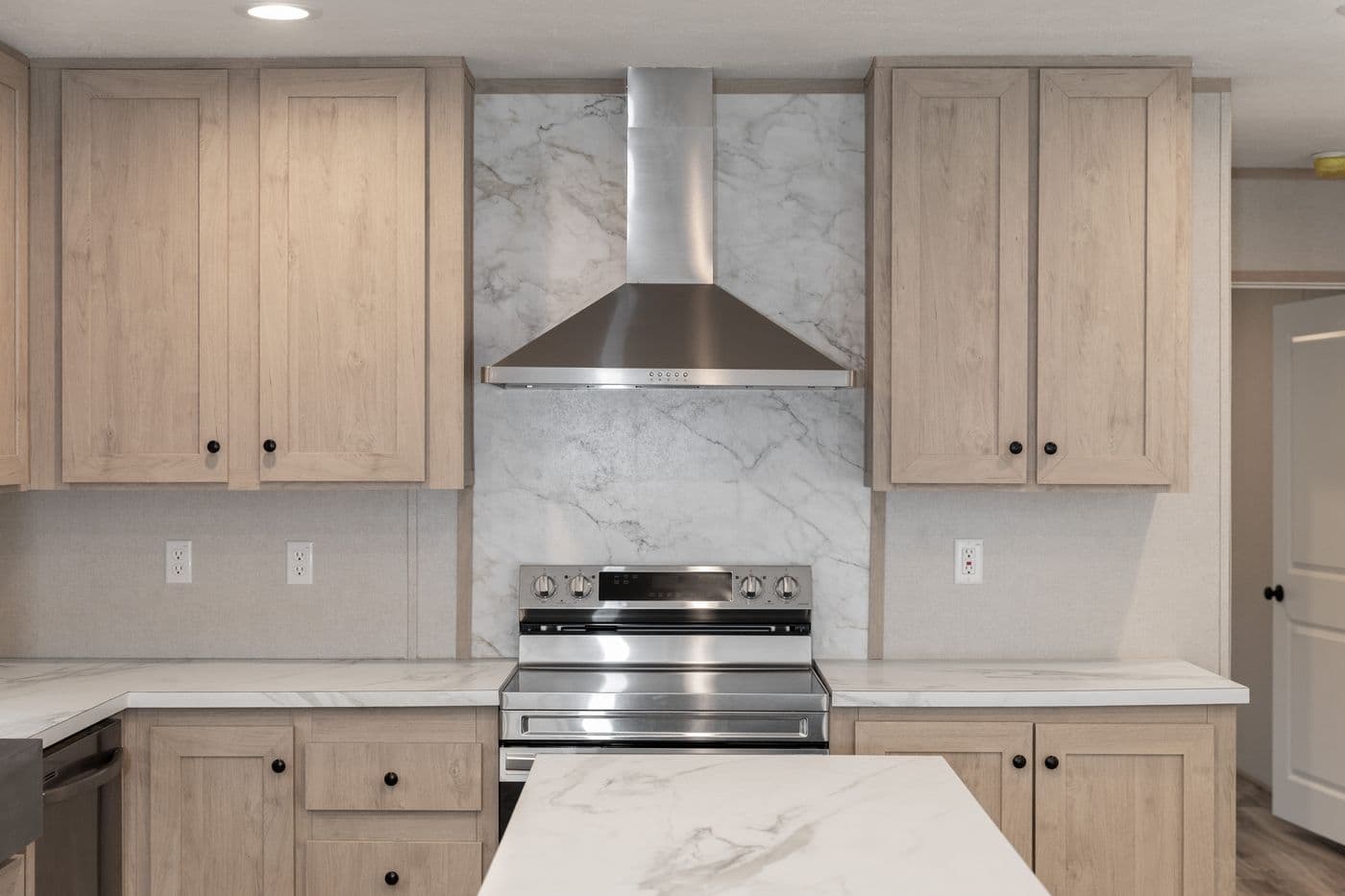 The THE ANNIVERSARY ISLANDER Kitchen. This Manufactured Mobile Home features 3 bedrooms and 2 baths.