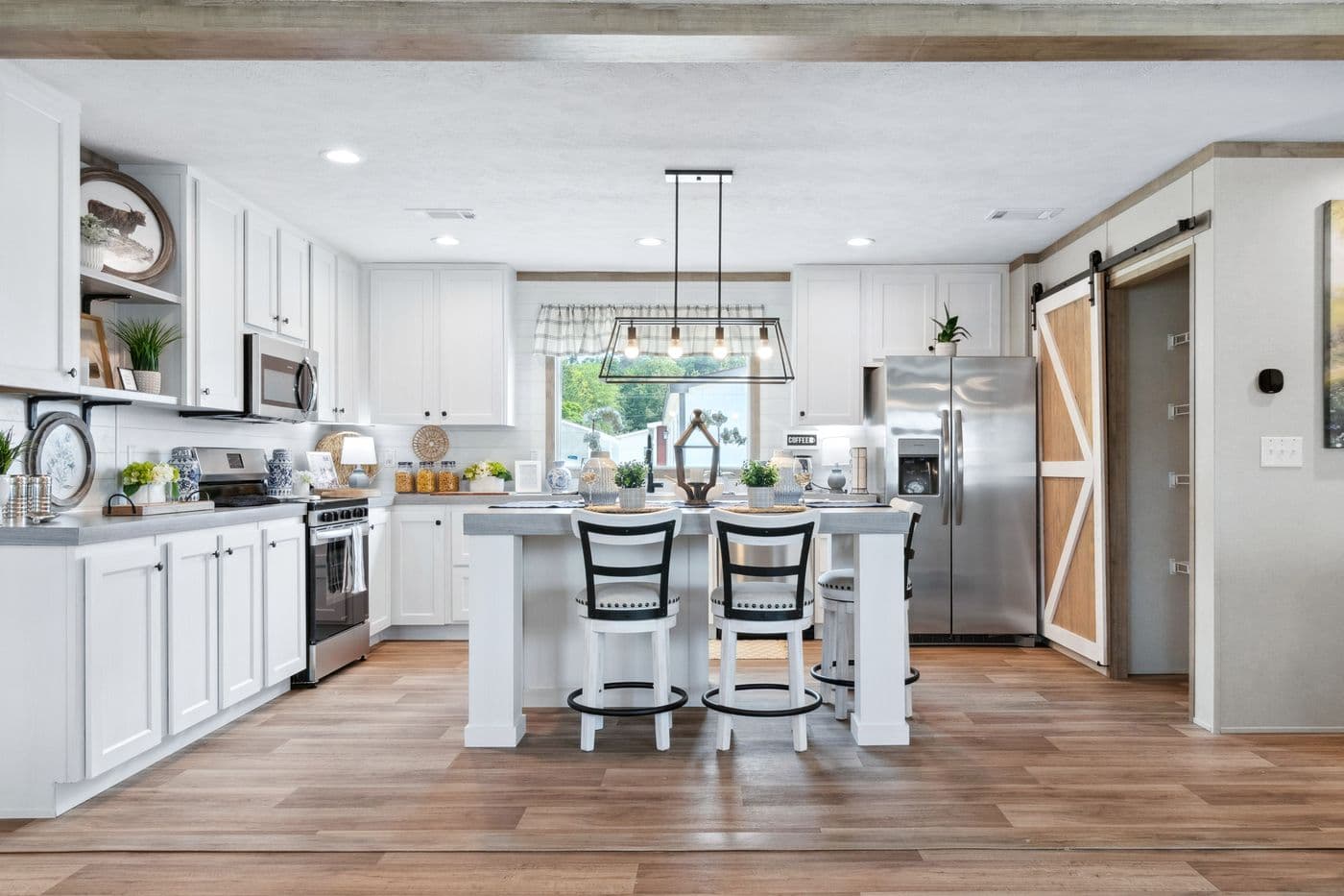The BREEZE FARMHOUSE 72 Kitchen. This Manufactured Mobile Home features 4 bedrooms and 2 baths.