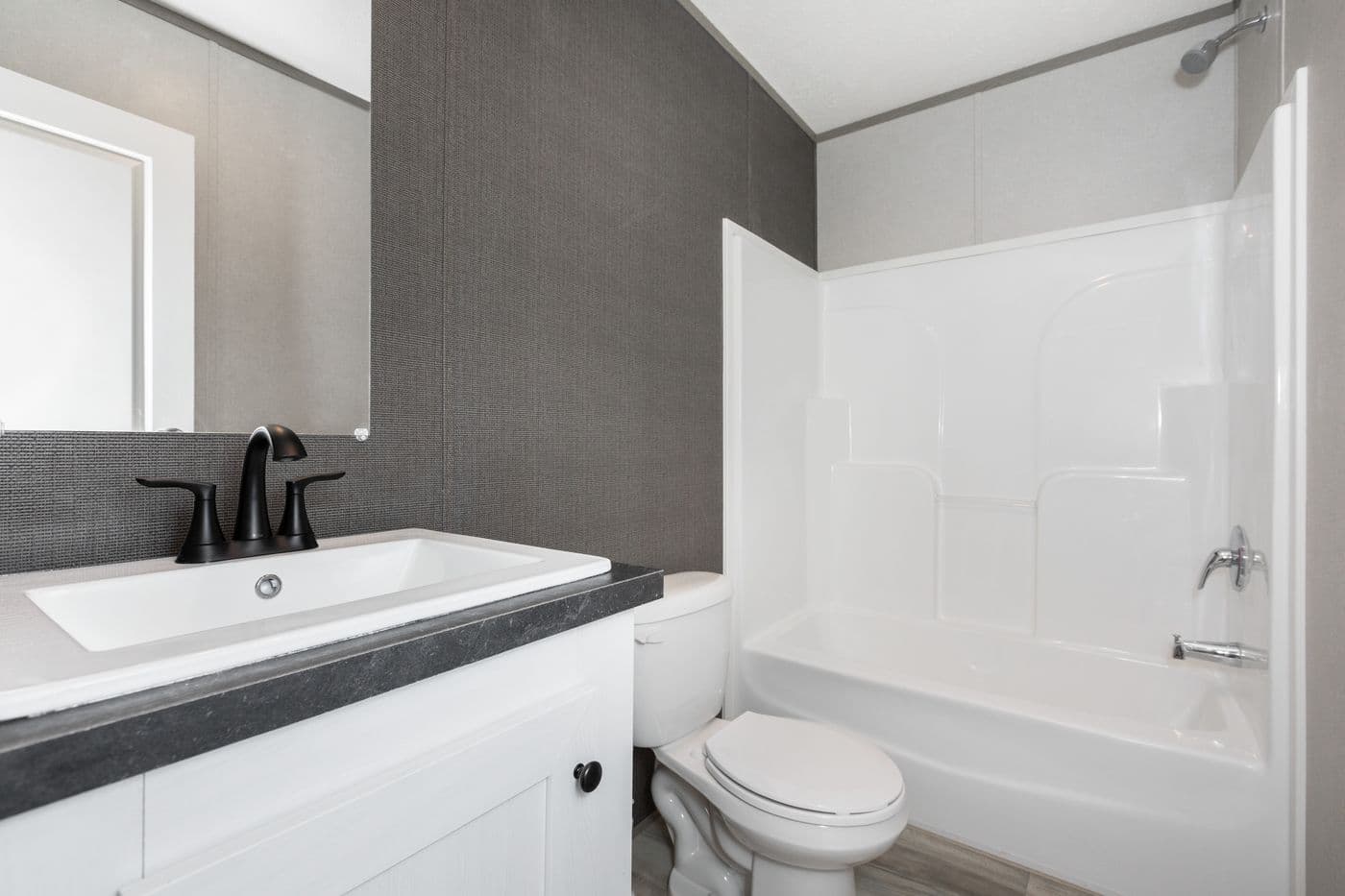The PLATINUM ANNIVERSARY Guest Bathroom. This Manufactured Mobile Home features 3 bedrooms and 2 baths.