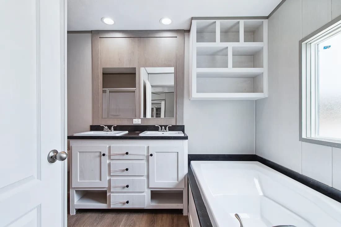 The ANNIVERSARY 16682F Primary Bathroom. This Manufactured Mobile Home features 2 bedrooms and 2 baths.