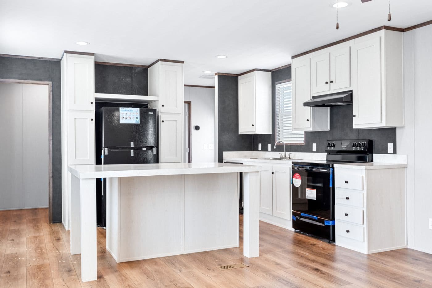 The HOMESTEAD 16683A Kitchen. This Manufactured Mobile Home features 3 bedrooms and 2 baths.
