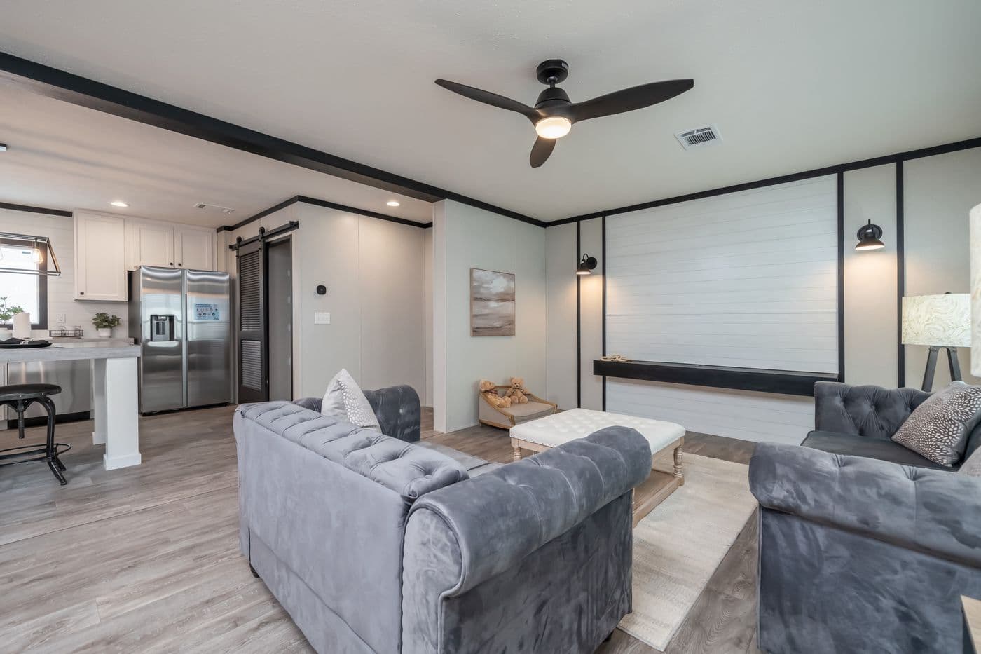 The BREEZE FARMHOUSE Living Room. This Manufactured Mobile Home features 3 bedrooms and 2 baths.