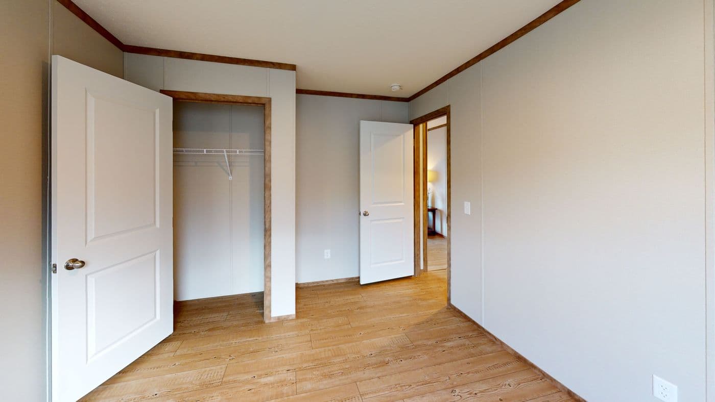 The BOONE Guest Bedroom. This Manufactured Mobile Home features 4 bedrooms and 2 baths.
